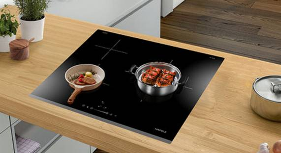 A kitchen counter with a pot and potted plant

AI-generated content may be incorrect.